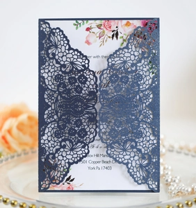 Detail of laser-cut lace navy blue pearlized wedding card with floral insert