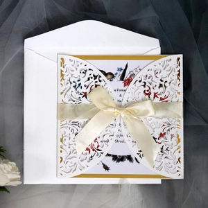 Elegant laser-cut wedding invitation set with floral inner card and white silk ribbon bow