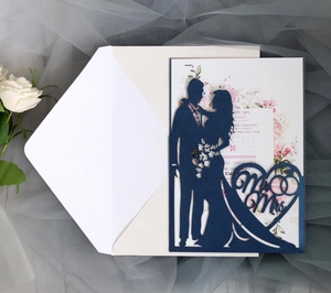 Detailed laser-cut wedding invitation featuring navy Mr & Mrs heart silhouette and floral insert