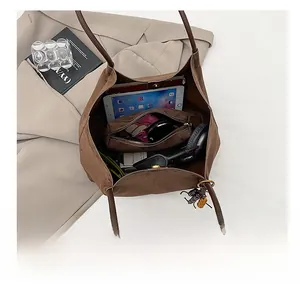 Macro view of a large brown suede tote bag interior showing spacious capacity for tablets