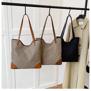 Three minimalist large tote bags in khaki, brown, and black high-density nylon fabric