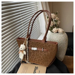 Brown leopard print tote bag with silver buckle strap and cute teddy bear charm