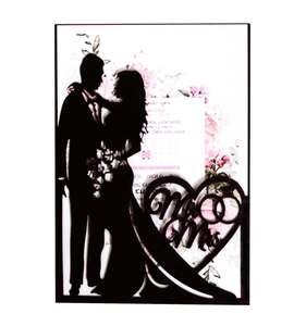 Detail of laser-cut black Mr & Mrs silhouette wedding invitation with heart and rings