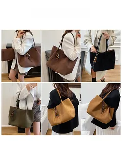 Lifestyle view showing large faux suede tote bag with fringe charm on female models
