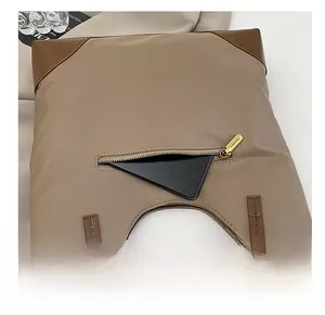 Macro view of the tote bag back zipper pocket with a smartphone inside for size reference