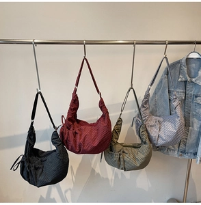 Selection of four plaid canvas crescent bags in black, red, green, and blue colors