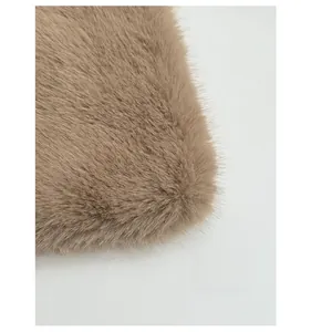 Detail of soft fluffy faux fur fabric in light brown with premium plush texture