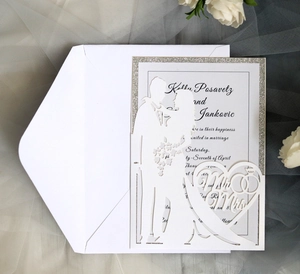 Detail of laser-cut Mr & Mrs wedding invitation with elegant silver glitter finish