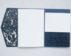 Detail showing deep blue laser-cut floral pattern and trifold structure of the wedding invitation