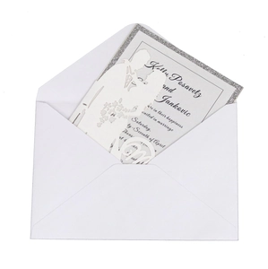 Laser-cut wedding invitation featuring a romantic couple silhouette and silver glitter inner