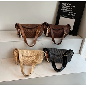 Detailed row of woven hobo bags in four colors with bohemian bead and wood charms