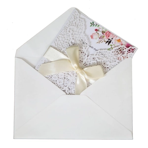 Elegant laser cut wedding invitation set with floral inner card and champagne ribbon