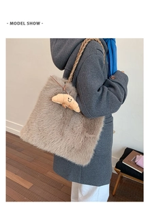 Detail of faux fur tote bag featuring soft texture and cute croissant plush pendant charm