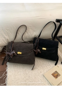 Detail of retro suede handbags with golden square buckles and cute dachshund pendants