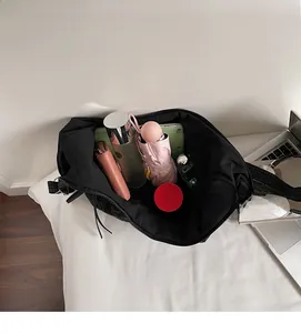 Interior view of large capacity plaid tote bag filled with daily essentials and tablet
