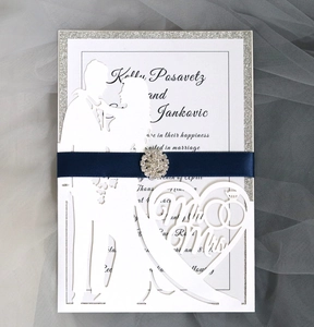 Detailed laser-cut wedding invitation with Mr & Mrs silhouette and navy silk ribbon