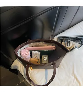 Intérieur spacieux du sac cabas en cuir marron foncé montrant le rangement quotidien