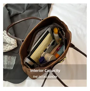 Interior view of brown suede tote bag showing striped lining and large capacity storage