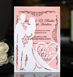 Detailed laser-cut wedding invitation featuring Mr & Mrs silhouettes and pink inner card