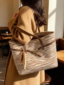 Zebra print suede tote bag with brown leather handles and vintage wooden beads tassel