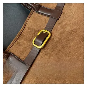 Detail view of dark brown suede tote bag featuring leather strap and gold buckle hardware