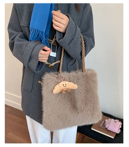 Brown faux fur tote bag detail with braided handles and croissant plush charm