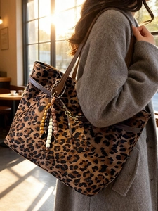 Large leopard print suede tote bag for women featuring a bohemian beaded tassel charm