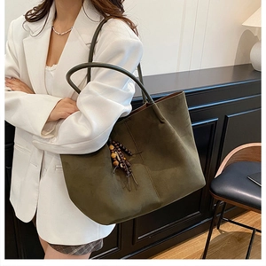 Olive green suede tote bag with wooden bead tassel and interior leather lining detail