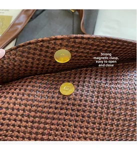 Macro shot of durable woven bag texture and secure gold-tone magnetic buckle closure