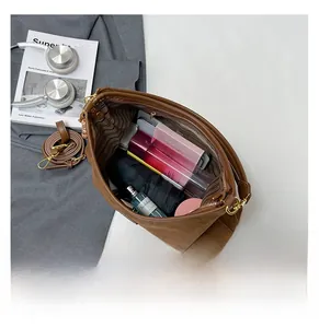 Detail view of large interior storage with striped lining and pockets for daily items