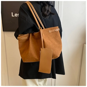 Brown suede tote bag side view featuring a metal buckle detail and small matching pouch