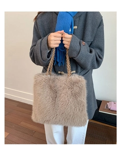 Detail of faux fur tote bag showing the plush texture and woven rope handle in light brown
