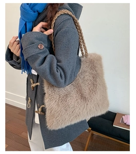 Detail of camel plush tote bag with textured woven strap and soft faux fur material