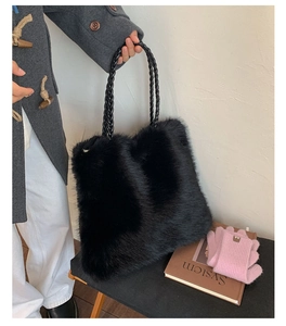 Detail of fluffy faux fur tote bag with a sophisticated braided leather handle