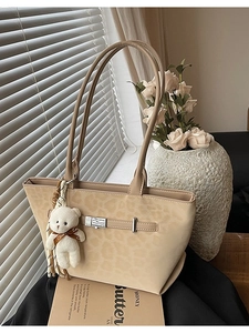 Light beige leopard embossed tote bag with silver buckle and cute teddy bear charm