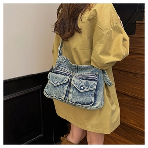 Détail d'un sac cabas en denim vintage avec plusieurs poches et bandoulière réglable
