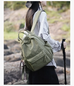 Olive green nylon backpack with large capacity and owl charm for outdoor travel use