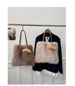 Detail of plush faux fur tote bags with woven rope handles and smiley croissant charm