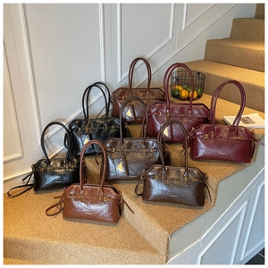 Detail view of retro faux oil wax leather tote bags in various vintage colors and textures