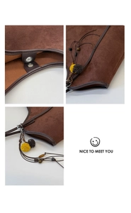 Detail view of dark brown suede tote bag with magnetic clasp and colorful pompom tassel