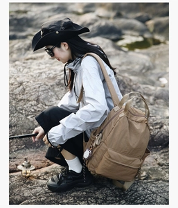 Close-up of durable textured nylon backpack used in a scenic outdoor hiking and camping setting