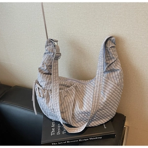 Detail of light purple checkered crescent bag with drawstring and wide strap