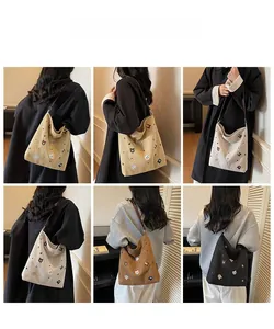 Detail showing various colors of canvas tote bags with cute animal embroidery on models