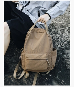 Outdoor khaky nylon backpack with multiple compartments and durable textured material