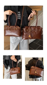 Detail of dark brown vintage pleated tote bags in large and small sizes with buckles