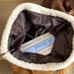 Top view of large brown suede tote with faux shearling trim showing spacious interior