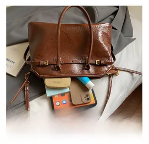 Brown vintage oil wax leather tote bag interior showing capacity for tablets and cosmetics