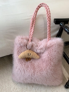 Pink faux fur tote bag with braided handles and a cute croissant plush pendant charm