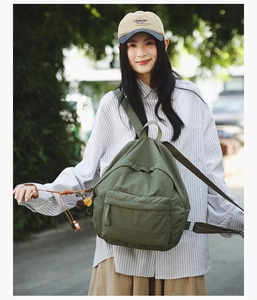 Olive green lightweight canvas backpack with ethnic charm and front zipper pocket