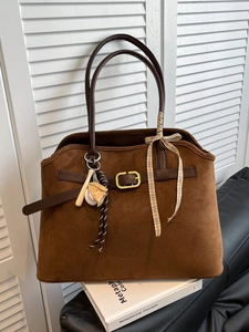 Brown large suede tote bag with leather belt detail and baseball charms for casual daily use